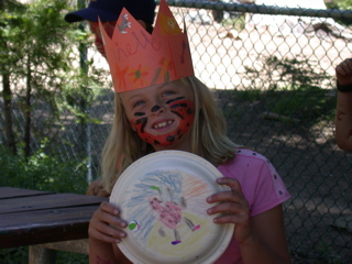 Marielle with face paint and tambourine