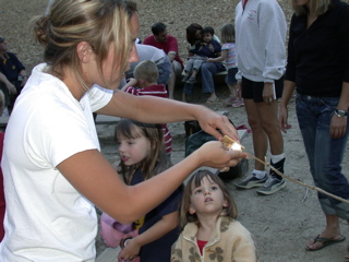 Heidi making the marshmallow into a s'mores